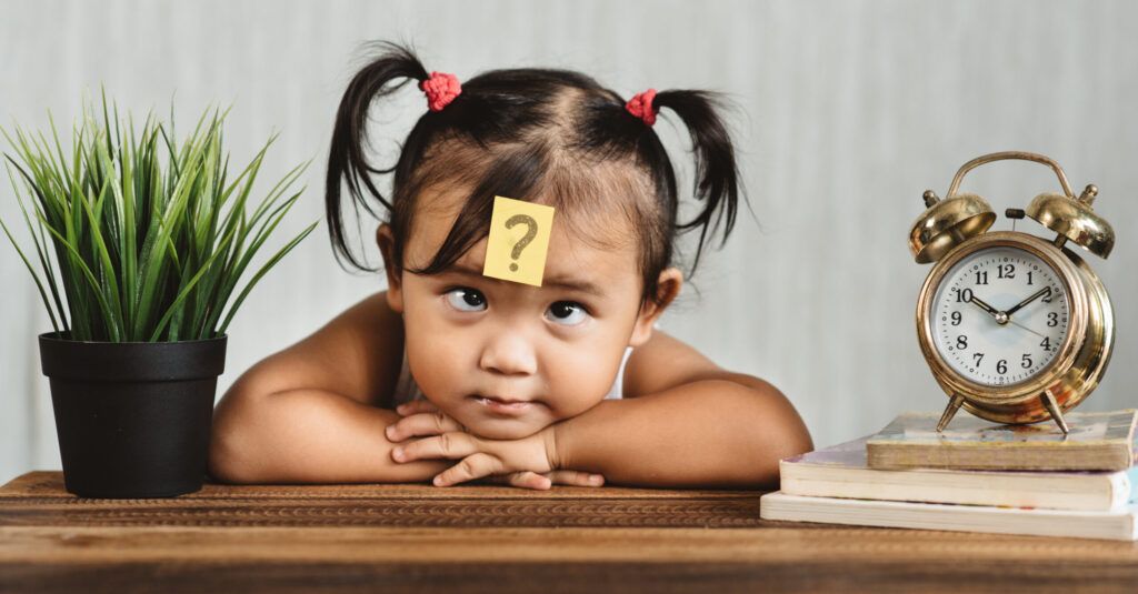 An image of clock and child presenting to idea of time and how to use it.