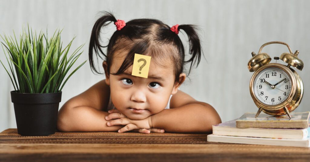 An image of clock and child presenting to idea of time and how to use it. 