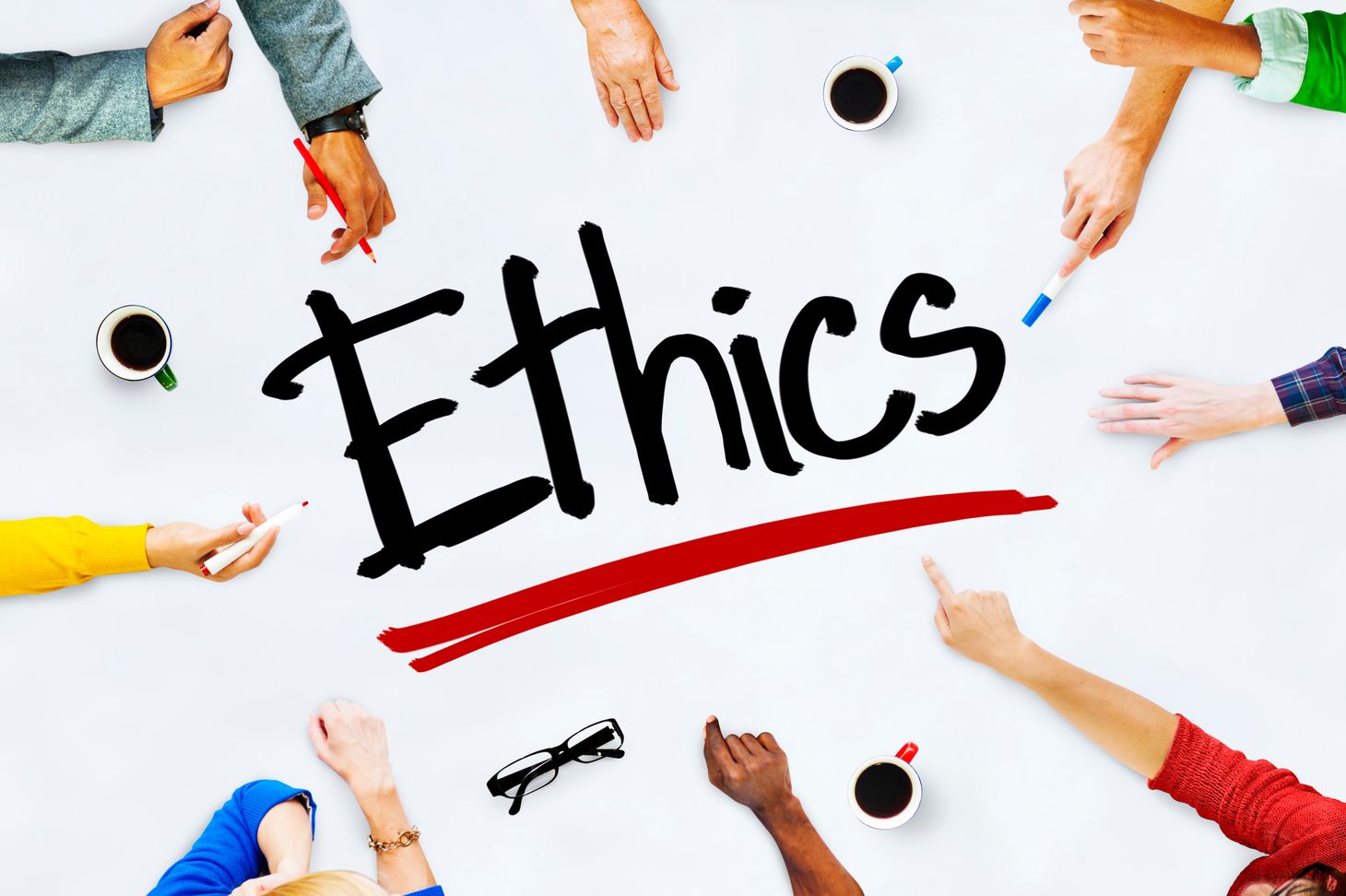 An image of the word ethics with people around the table. 