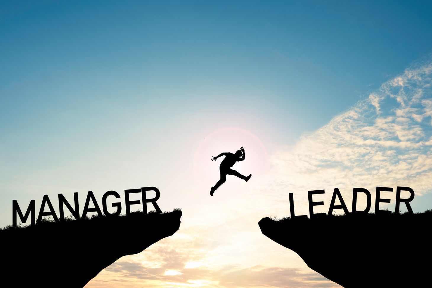 Image of a person jumping from being a manager to becoming a leader. 